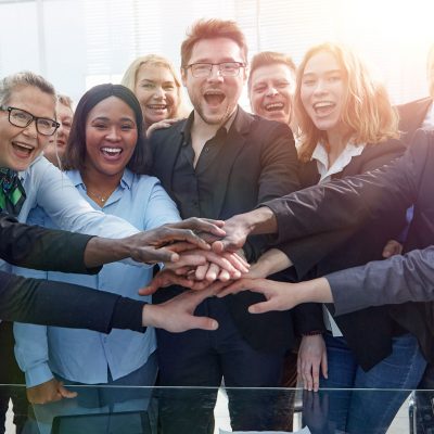 Business team stacking their hands together for motivation and cooperation